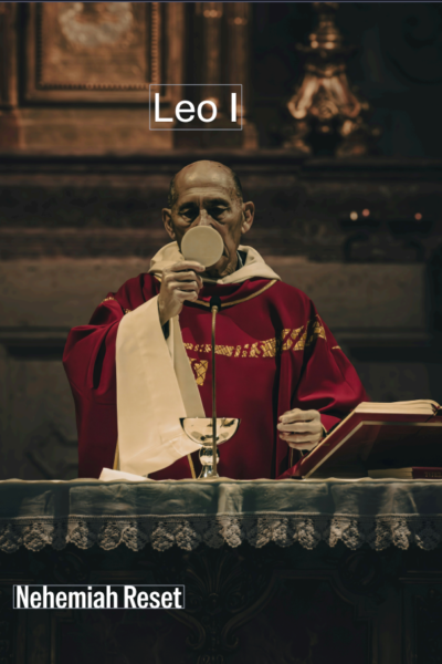 Catholic priest in red vestments at the altar holding a communion wafer to his lips